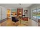 Bright dining room features an elegant glass table set and unique artwork at 2920 Pony Ln, Sarasota, FL 34232