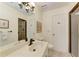 Bright bathroom features a modern sink with a black faucet, neutral tiling, and a glass-enclosed shower at 3111 Bayou Sound, Longboat Key, FL 34228