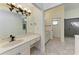 Bathroom with dual sinks and white cabinetry at 3111 Bayou Sound, Longboat Key, FL 34228