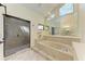 Bathroom featuring a soaking tub, a glass-enclosed shower, and natural light at 3111 Bayou Sound, Longboat Key, FL 34228
