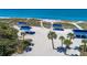 Picturesque beachfront with covered picnic areas and palm trees for a relaxing day at 3111 Bayou Sound, Longboat Key, FL 34228