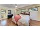 Cozy bedroom with hardwood floors, ceiling fan, and an ensuite bathroom at 3111 Bayou Sound, Longboat Key, FL 34228