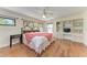 Comfortable bedroom with hardwood floors, built-in shelving, and a large bed at 3111 Bayou Sound, Longboat Key, FL 34228