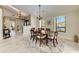 Elegant dining room with decorative chandelier, light paint, and large window for ample natural light at 3111 Bayou Sound, Longboat Key, FL 34228