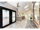Bright foyer with tile flooring, skylights, and a decorative glass door, leads to the dining room at 3111 Bayou Sound, Longboat Key, FL 34228