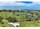 Scenic aerial view of a golf course with water features and coastal views at 3111 Bayou Sound, Longboat Key, FL 34228