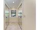 Hallway featuring mirrored closet doors and natural light at 3111 Bayou Sound, Longboat Key, FL 34228