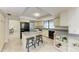 Well-lit kitchen with granite countertops, stainless steel appliances, and a center island with seating at 3111 Bayou Sound, Longboat Key, FL 34228