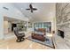 Spacious living room with stone fireplace, hardwood floors, and seamless access to the kitchen and screened-in lanai at 3111 Bayou Sound, Longboat Key, FL 34228