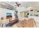 Open concept living room featuring a spiral staircase, stone fireplace, and seamless access to the kitchen area at 3111 Bayou Sound, Longboat Key, FL 34228