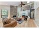 Bright living room features vaulted ceilings, stone fireplace, hardwood floors, and spiral staircase to the second floor at 3111 Bayou Sound, Longboat Key, FL 34228
