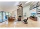 Inviting living room with a stone fireplace, hardwood floors, and a vaulted ceiling with a fan at 3111 Bayou Sound, Longboat Key, FL 34228
