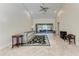 Comfortable living room featuring tile floors, and access to a screened-in patio at 3111 Bayou Sound, Longboat Key, FL 34228