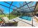 Relaxing screened-in pool with a chaise lounge and a view of the backyard at 3111 Bayou Sound, Longboat Key, FL 34228