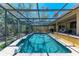 Inviting screened-in pool with clear blue water and outdoor lounging area at 3111 Bayou Sound, Longboat Key, FL 34228