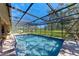 Beautiful screened-in pool with clear water and scenic backyard views at 3111 Bayou Sound, Longboat Key, FL 34228