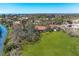 Expansive property boasts a lush green lawn, mature trees, and waterfront access at 3111 Bayou Sound, Longboat Key, FL 34228