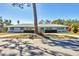Charming single-story home with manicured front yard, lush greenery, and decorative shutters at 3124 Tanglewood Dr, Sarasota, FL 34239