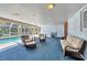 Comfortable covered lanai with pool access and outdoor seating with a swinging bench at 3124 Tanglewood Dr, Sarasota, FL 34239