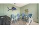 Inviting outdoor balcony featuring blue chairs and a grill, perfect for enjoying the serene waterfront view at 314 Bay S Dr # 5, Bradenton Beach, FL 34217
