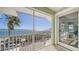 Scenic balcony view of the waterfront with lush palm trees and boats sailing on the open water at 314 Bay S Dr # 5, Bradenton Beach, FL 34217