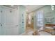 Bathroom featuring double sinks, granite counters, and glass enclosed shower with tiled walls at 314 Bay S Dr # 5, Bradenton Beach, FL 34217