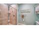 Bathroom featuring neutral tile walls, a glass shower stall, and decorative wall accents at 314 Bay S Dr # 5, Bradenton Beach, FL 34217