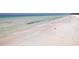 Tranquil beach scene featuring crystal-clear turquoise water meeting the white sandy shore at 314 Bay S Dr # 5, Bradenton Beach, FL 34217