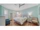 Inviting bedroom features a queen bed, wood floors, ceiling fan, and coastal decor at 314 Bay S Dr # 5, Bradenton Beach, FL 34217