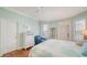 Bedroom features hardwood floors, ceiling fan, blue decor, and shuttered windows at 314 Bay S Dr # 5, Bradenton Beach, FL 34217