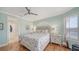 Bright bedroom with hardwood floors, ceiling fan, and queen size bed at 314 Bay S Dr # 5, Bradenton Beach, FL 34217