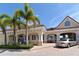 Commercial building with beige stucco, red tile roof, white columns, and manicured greenery at 314 Bay S Dr # 5, Bradenton Beach, FL 34217