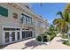 Attractive building with decorative balconies, multiple entryways, lush landscaping, and a sidewalk at 314 Bay S Dr # 5, Bradenton Beach, FL 34217