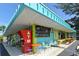 Colorful commercial building with an ATM, chalkboard menu, and outdoor seating at 314 Bay S Dr # 5, Bradenton Beach, FL 34217
