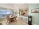 Cozy dining area with a round table, woven chairs, and a view of the waterfront and modern kitchen at 314 Bay S Dr # 5, Bradenton Beach, FL 34217