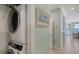 A laundry room with a stacked washer and dryer set, located near the living area at 314 Bay S Dr # 5, Bradenton Beach, FL 34217