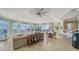Living room featuring tile floors, walls of windows, and views of the water at 314 Bay S Dr # 5, Bradenton Beach, FL 34217