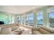 Cozy living room featuring tile floors, comfortable seating, and stunning waterfront views at 314 Bay S Dr # 5, Bradenton Beach, FL 34217