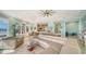 Spacious living room with abundant natural light, stylish decor, and seamless connection to the kitchen at 314 Bay S Dr # 5, Bradenton Beach, FL 34217
