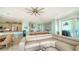 Bright, open-concept living room with modern furniture and seamless flow to the kitchen and waterfront balcony at 314 Bay S Dr # 5, Bradenton Beach, FL 34217