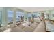Elegant living room featuring walls of windows offering panoramic views of the water and surrounding landscape at 314 Bay S Dr # 5, Bradenton Beach, FL 34217