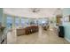 Open concept living and dining area with tile floors, walls of windows and water views at 314 Bay S Dr # 5, Bradenton Beach, FL 34217