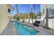 A beautiful outdoor pool surrounded by a wooden deck and lush tropical landscaping at 314 Bay S Dr # 5, Bradenton Beach, FL 34217