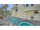 Inviting outdoor pool and hot tub on wooden deck with hose and other seating at 314 Bay S Dr # 5, Bradenton Beach, FL 34217