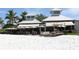 Charming beachfront restaurant with outdoor seating and umbrellas on a sunny day at 314 Bay S Dr # 5, Bradenton Beach, FL 34217