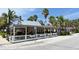 Inviting restaurant with a striped awning, outdoor dining space, and well-maintained landscaping at 314 Bay S Dr # 5, Bradenton Beach, FL 34217