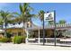 Charming restaurant exterior featuring a striped awning, outdoor seating, and lush tropical foliage at 314 Bay S Dr # 5, Bradenton Beach, FL 34217