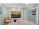 An inviting sitting room featuring a large wall mounted television and a serene beach painting at 314 Bay S Dr # 5, Bradenton Beach, FL 34217