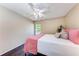 Bright bedroom with wood floors, neutral walls, ceiling fan, and a large window at 3549 Wilkinson Woods Dr # 38, Sarasota, FL 34231