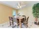 Well lit Dining room area with a ceiling fan, view of the yard, and bamboo plant at 3549 Wilkinson Woods Dr # 38, Sarasota, FL 34231